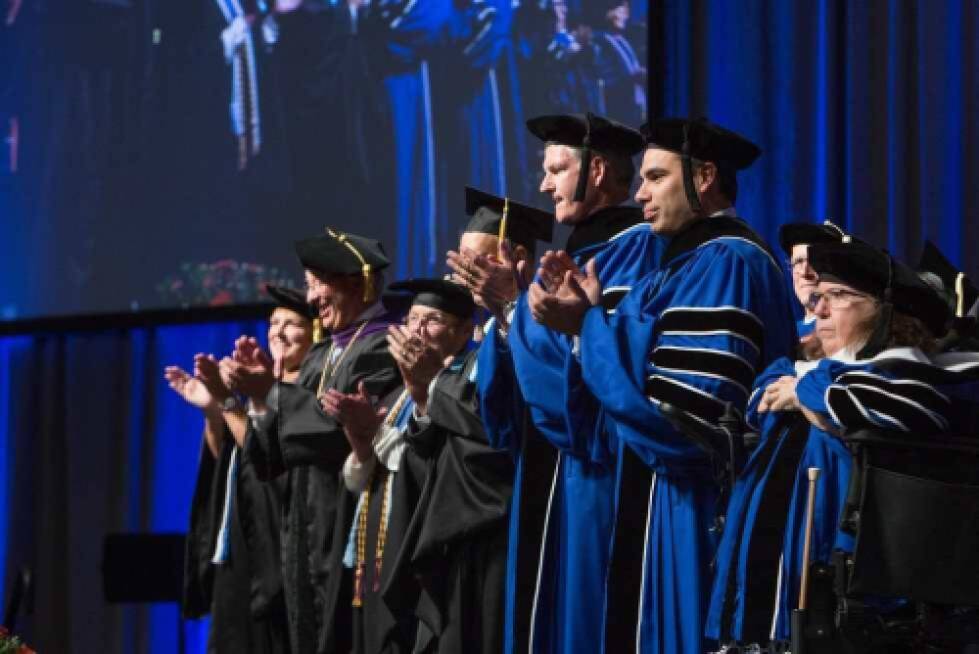 Faculty at Convocation Ceremony dressed in caps and gowns
